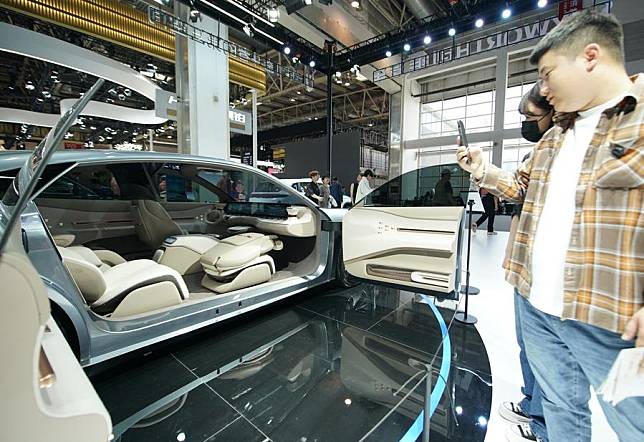 People watch a vehicle at the booth of Skyworth Auto at the 2024 Beijing International Automotive Exhibition in Beijing, China, April 30, 2024. (Xinhua/Zhang Chenlin)