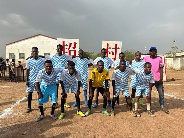 Players of the football team from the neighboring area of the Belle Cite Village pose for photos after competition in Benin, Africa, March 2024. (Xinhua)