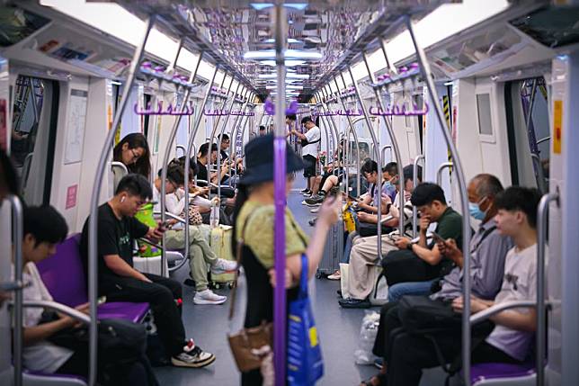 People ride a subway train adorned with the 19th Asian Games elements in Hangzhou, capital of east China's Zhejiang Province on Sept. 5, 2023. (Xinhua/Jiang Han)