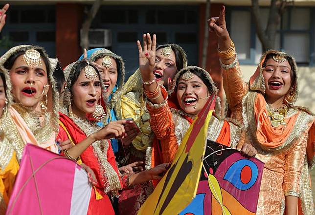 Indian college students wearing traditional Punjabi attire celebrate the Lohri festival in Amritsar district of India's northern Punjab state, Jan. 13, 2025. (Str/Xinhua)