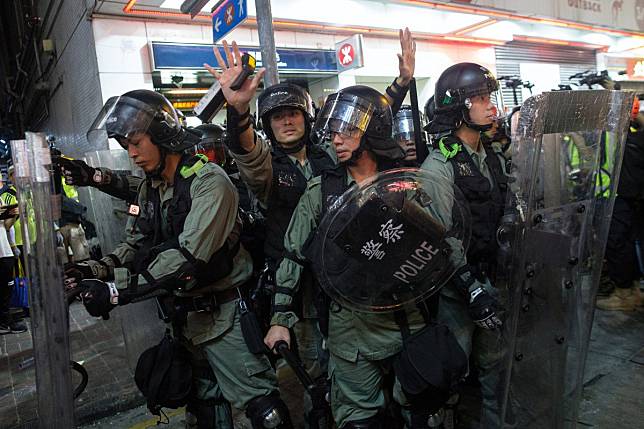 Riot police retreat after clashes with protesters on Sunday. A Save the Children spokeswoman said the decision to cancel the event was made “in light of the recent protests in Hong Kong”. Photo: EPA-EFE