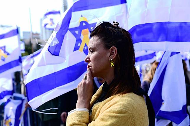 People watch the televised broadcast of the handover of the bodies of Israeli hostages at a square in Tel Aviv, Israel, on Feb. 20, 2025. (Tomer Neuberg/JINI via Xinhua)