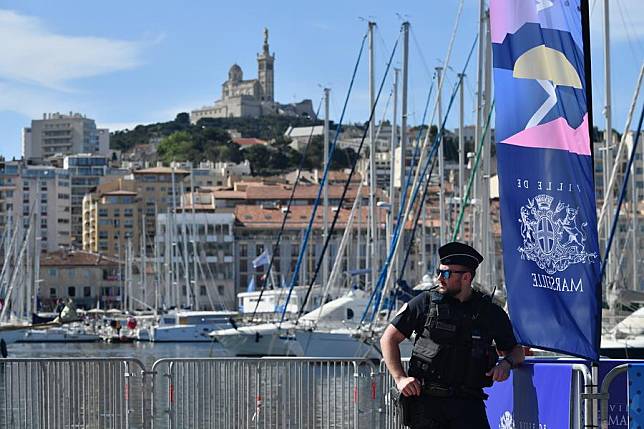 A policeman patrols before the arrival of the Olympic flame at the old port in Marseille, southern France, on May 8, 2024. (Photo by Julien Mattia/Xinhua)
