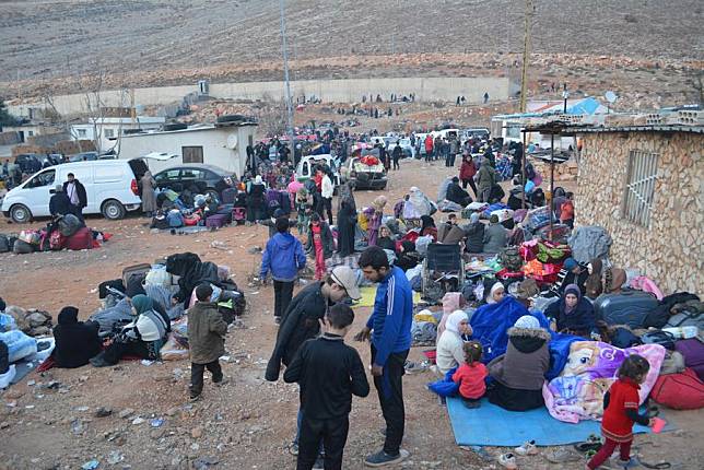 Syrians fleeing Syria are stuck at the border with Lebanon in the Masnaa border crossing area on Dec. 12, 2024. (Photo by Maher Kamar/Xinhua)