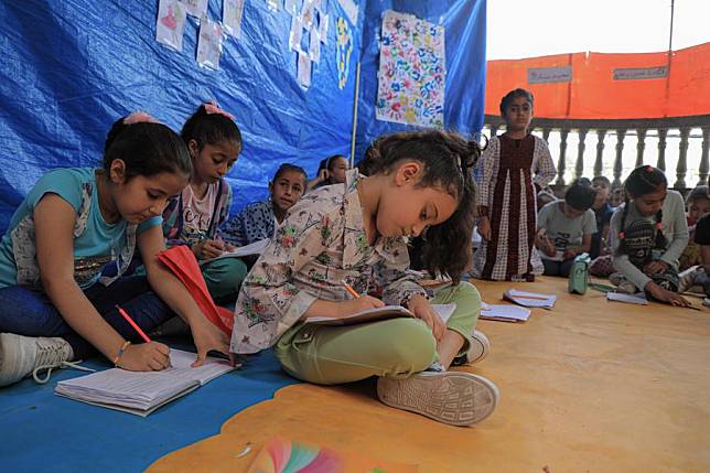 Children study at a temporary school in the city of Deir al-Balah in central Gaza Strip, May 20, 2024. (Photo by Rizek Abdeljawad/Xinhua)