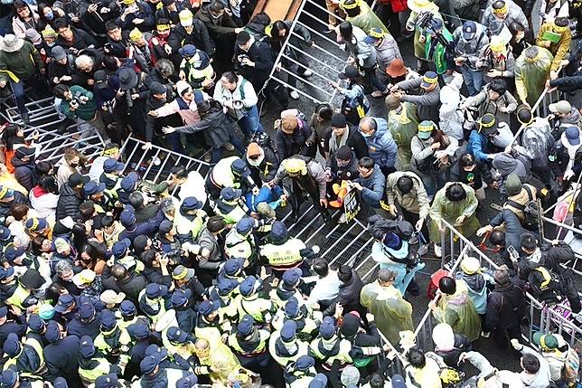 修法當下，立院外有人推倒柵欄試圖衝進立院，與警方僵持。（王侑聖攝）