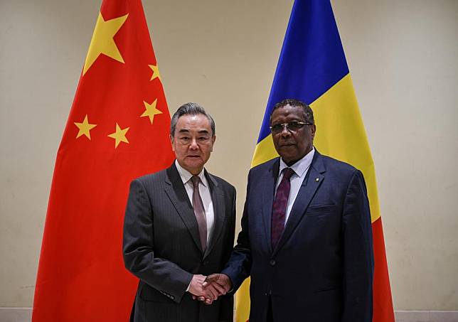 Chinese Foreign Minister Wang Yi (L), also a member of the Political Bureau of the Communist Party of China Central Committee, shakes hands with Chadian Foreign Minister Abderaman Koulamallah during their meeting in N'Djamena, Chad, on Jan. 8, 2025. (Xinhua/Han Xu)