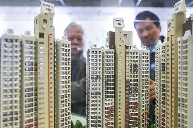 Potential homebuyers on Monday inspect a scale model at the Housing Authority in Lok Fu. Photo: Dickson Lee