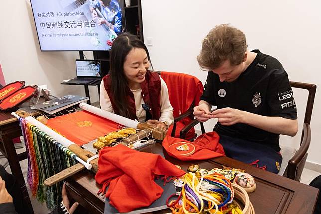 A man tries Suzhou embroidery at a Chinese culture promoting event in Budapest, Hungary, Jan. 17, 2025. (Photo by Attila Volgyi/Xinhua)