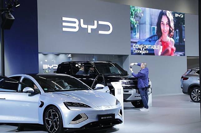 People take pictures at the booth of BYD at the Automechanika in Frankfurt, Germany, Sept. 11, 2024. (Xinhua/Zhang Fan)