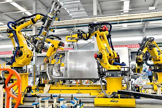 Robots work on an assembly line of aluminium vehicle body in Zouping, east China's Shandong Province, Sept. 13, 2023. (Xinhua/Guo Xulei)