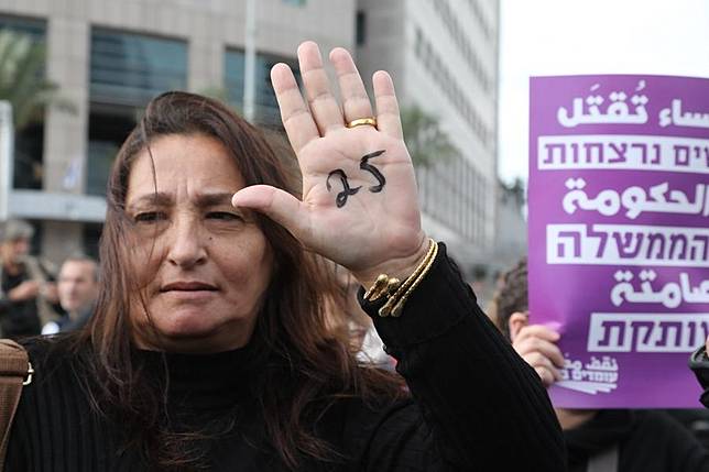 A human rights activist protests against violence toward women in Tel Aviv, Israel, on Dec. 12, 2018. After a woman was stabbed to death on Tuesday in her home, a total of 25 women and girls have been murdered in Israel since the beginning of 2018. (Xinhua/JINI/Gideon Markovich)