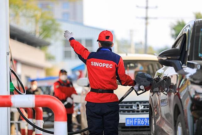 A staff member refuels a vehicle at a gas station in Congjiang County, southwest China's Guizhou Province, Jan. 3, 2023. (Photo by Luo Jinglai/Xinhua)