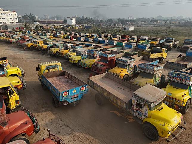 Trucks with traditional painting and decorations are parked in Gabtali of Dhaka, Bangladesh, Dec. 19, 2024. (Xinhua)