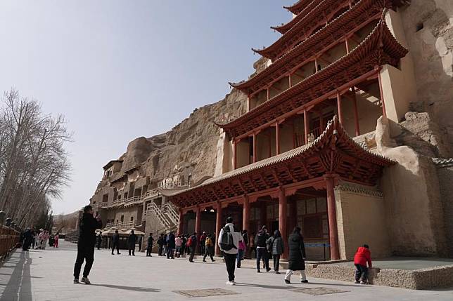 Tourists visit the Mogao Grottoes in Dunhuang, northwest China's Gansu Province, March 16, 2024. (Xinhua/Zhang Zhimin)