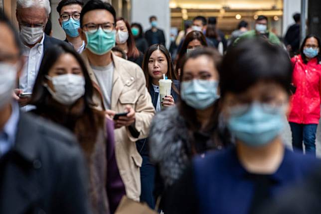 Pedestrians wear face masks in Central district of Hong Kong