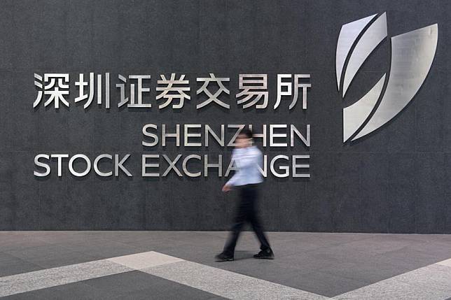 A staff member walks past the Shenzhen Stock Exchange in Shenzhen, south China's Guangdong Province, Sept. 21, 2020. (Xinhua/Mao Siqian)