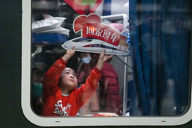 A child holds a placard reading &ldquo;go home for the New Year&rdquo; aboard train K4159, the first train to depart from Beijing for this year's Spring Festival travel rush at Beijing West Railway Station in Beijing, capital of China, Jan. 13, 2025. The Spring Festival travel rush of this year started on Tuesday and will last til Feb. 22. A total of 9 billion inter-regional trips are expected during the 40-day travel surge. (Xinhua/Ju Huanzong)