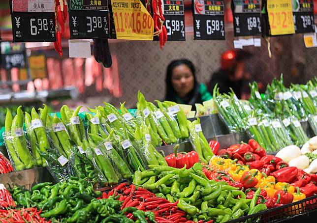 A customer shops at a supermarket in Congjiang County, southwest China's Guizhou Province, March 9, 2024. (Photo by Luo Jinglai/Xinhua)