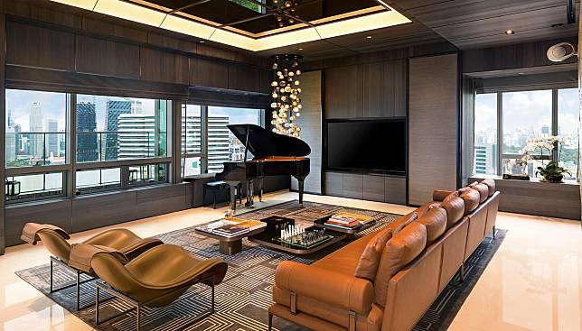 A grand piano sits under a hanging chandelier in the living room, with panoramic views of Singapore’s cityscape on full display