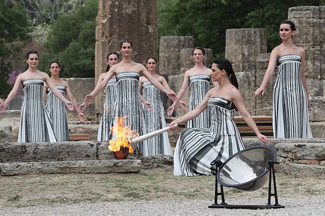 Actress Mary Mina, in the role of High Priestess, lights the torch during the Olympic flame lighting ceremony for the Paris 2024 Summer Olympic Games in Ancient Olympia, Greece, on April 16, 2024. (Xinhua/Li Jing)