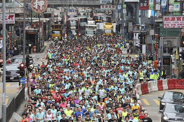 Participants run through Nathan Road in Mong Kok during the 2019 Standard Chartered Hong Kong Marathon. Photo: Dickson Lee