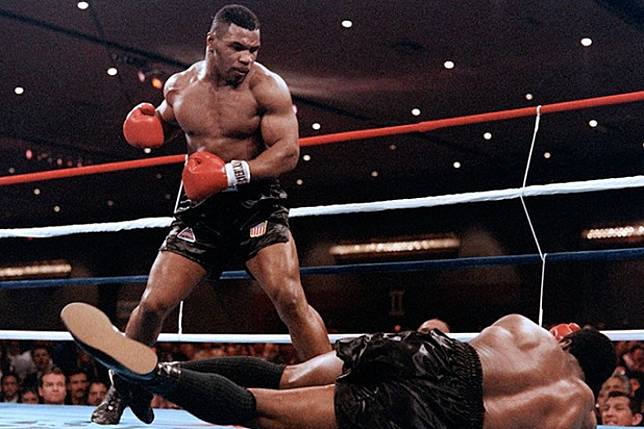 Mike Tyson knocks out Trevor Berbick on his way to becoming the youngest heavyweight champion in history in November 1986. Photo: Carlos Schiebeck/AFP