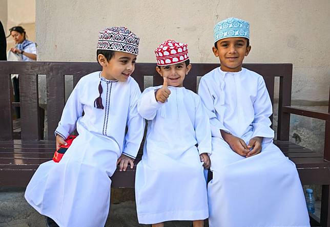 Children rest in the Nizwa Fort scenic area in Nizwa, Oman, Jan. 10, 2025. Nizwa Fort, a large circular castle, is a famous tourist attraction in Oman. (Xinhua/Liu Lei)