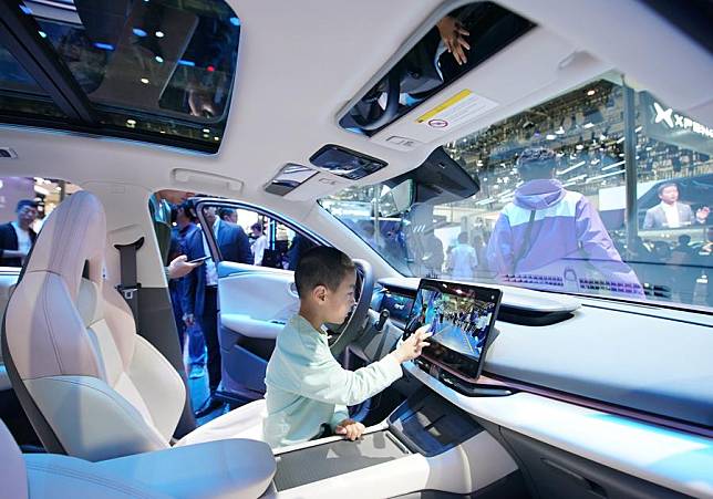 A child experiences a Lynk &amp; Co's new energy vehicle at the 2024 Beijing International Automotive Exhibition in Beijing, China, April 30, 2024. (Xinhua/Zhang Chenlin)