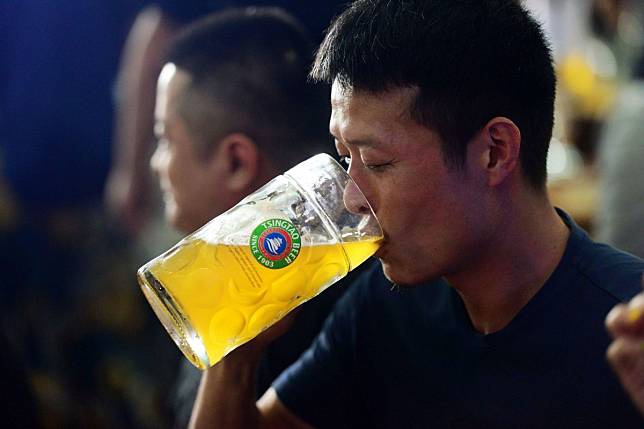 Analysts think beer makers will suffer from the coronavirus. Beer stocks fell hard Friday in Hong Kong. Here, a beer lover enjoys a drink at the Qingdao International Beer Festival in Qingdao city, east China's Shandong province, on July 31, 2019.