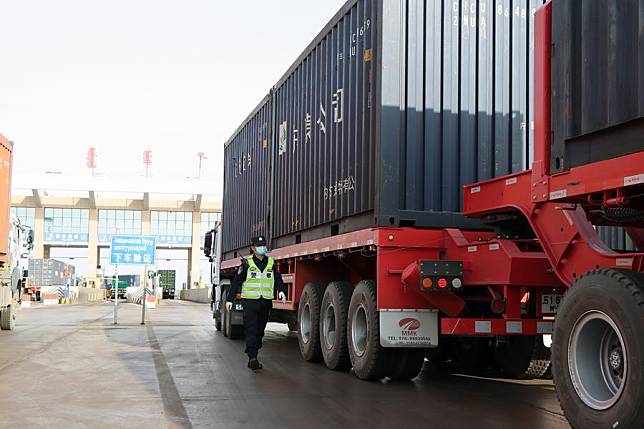 This photo taken on April 3, 2024 shows a border police inspecting a cargo truck at Ganqmod Port in the city of Bayannur, north China's Inner Mongolia Autonomous Region. (Xinhua/Li Yunping)