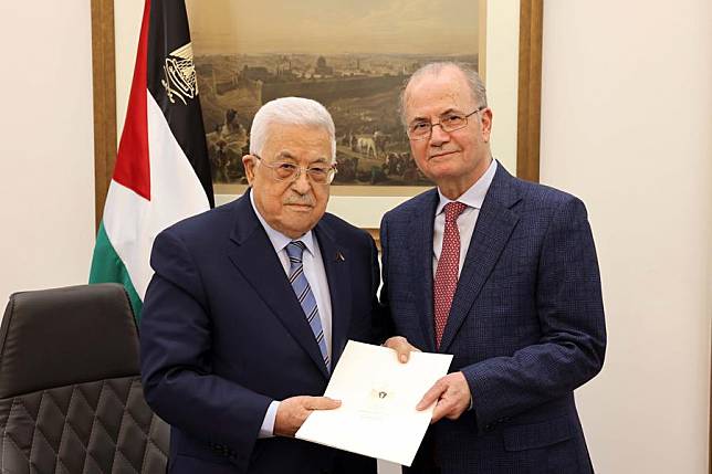 Palestinian President Mahmoud Abbas (L) hands a mandate to Mohammad Mustafa in the West Bank City of Ramallah, on March 14, 2024. Abbas on Thursday (March 14) tasked Mustafa to form the 19th government, the official news agency WAFA reported. (Palestinian President Office/Handout via Xinhua)