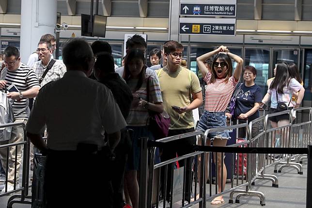 Travellers queue to go through a security check before entering Hong Kong International Airport earlier this month following anti-government protests. With travel to and from the city down sharply, airlines have slashed fares to fill seats. Photo: Sam Tsang