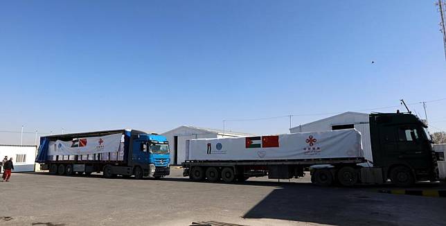 Trucks loaded with Chinese aid get ready to set off from the warehouse of Jordan Hashemite Charity Organization in Zarqa, Jordan, on Feb. 18, 2025. (Photo by Mohammad Abu Ghosh/Xinhua)