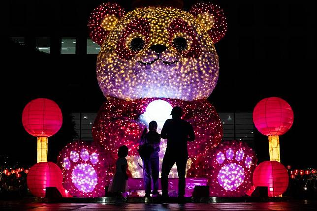 People stand in front of an illuminated giant panda decoration in celebration of the upcoming Lunar New Year in Jakarta, Indonesia, on Jan. 24, 2025. (Xinhua/Veri Sanovri)