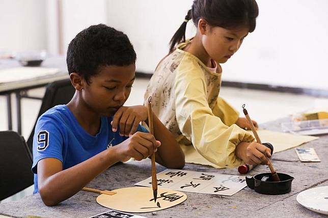 Children learn Chinese calligraphy at the Chinese Cultural Center in Dar es Salaam, Tanzania, on Nov. 8, 2024. (Xinhua/Emmanuel Herman)