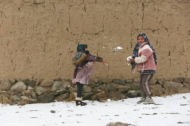 Children play with snow in Paghman District, Kabul, capital of Afghanistan, Dec. 16, 2024. (Photo by Saifurahman Safi/Xinhua)