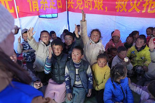 Children raise hands to answer questions during a psychology class given by a social work service center at a relocation site of quake-affected residents in a village in Dingri County in Xigaze, southwest China's Xizang Autonomous Region, Jan. 8, 2025. (Xinhua/Jigme Dorje)