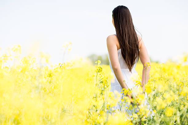 Young woman in the spring field