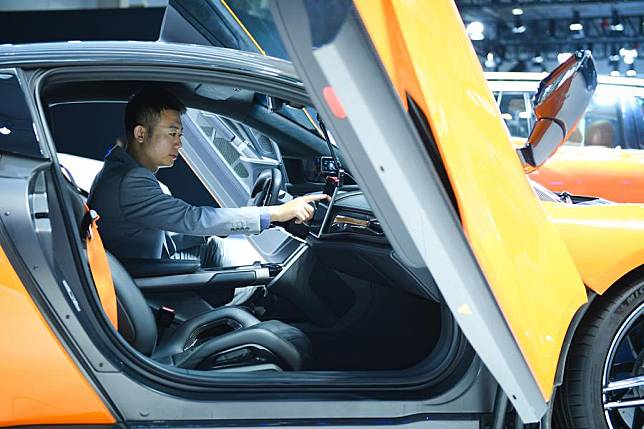 A staff member of Chinese automaker GAC Group debugs an electric sports car during the 2024 World Intelligent Connected Vehicles Conference in Beijing, capital of China, Oct. 17, 2024. (Xinhua/Chen Zhonghao)