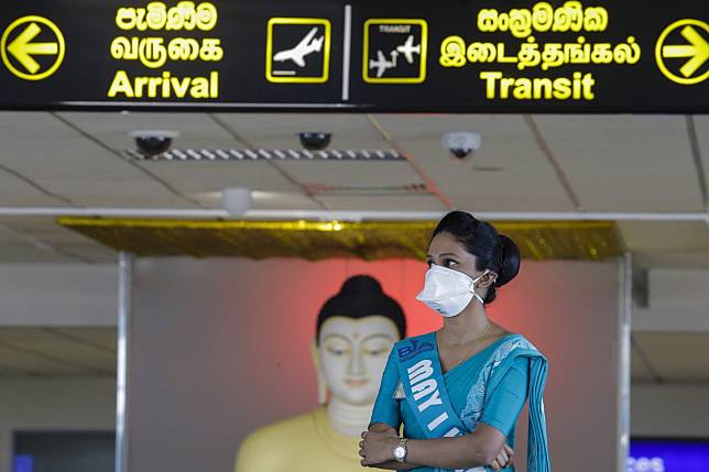 A worker at Bandaranaike International Airport in Colombo, Sri Lanka, wears a cloth mask to protect herself against the coronavirus on Friday. Photo: EPA-EFE