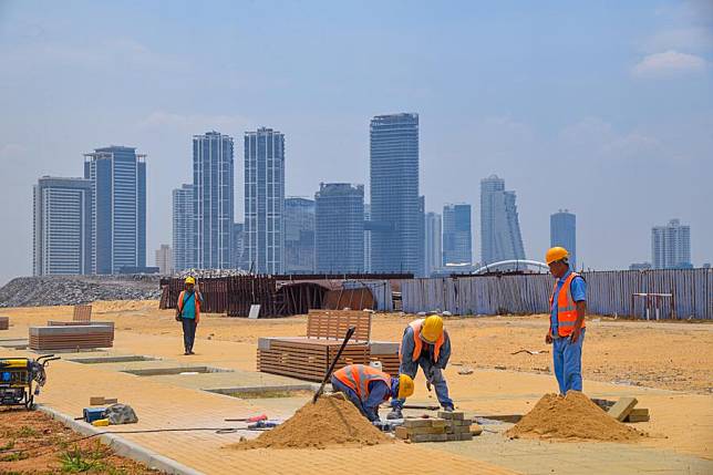 Workers work at a construction site of the Colombo Port City in Sri Lanka, March 27, 2024. The Colombo Port City, located near Colombo's central business district, is a flagship project regarded as a model of Belt and Road cooperation between China and Sri Lanka. (Xinhua/Xu Qin)