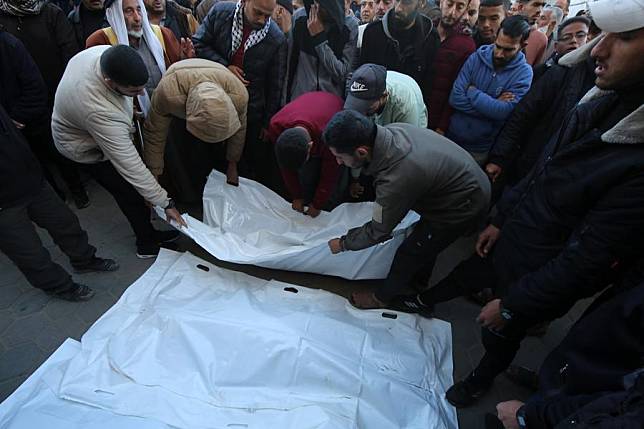 People lay the body of a victim on the ground of a hospital in Deir al-Balah city, central Gaza Strip, on Jan. 8, 2025. (Photo by Rizek Abdeljawad/Xinhua)