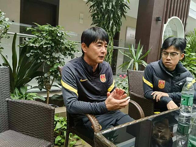 Bin Ukishima (L), head coach of China's U15 football team, speaks in an interview with Xinhua. (Xinhua)