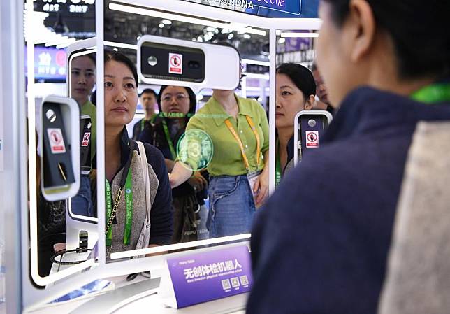 Visitors try a non invasive physical examination robot at the Incubation Special Section during the 7th China International Import Expo (CIIE) in east China's Shanghai, Nov. 9, 2024. (Xinhua/Jin Mamengni)