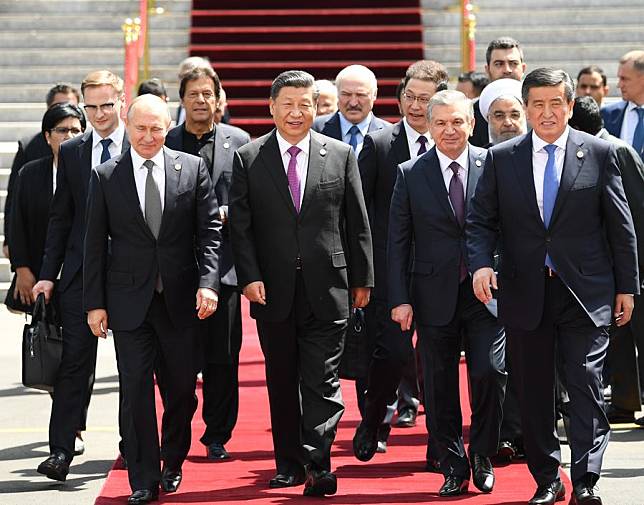 Chinese President Xi Jinping (2nd L, front) and other leaders of the Shanghai Cooperation Organization (SCO) member countries and observer states, as well as representatives of regional and international bodies, head for group photos during the 19th meeting of the Council of Heads of State of the SCO in Bishkek, Kyrgyzstan, June 14, 2019. (Xinhua/Yin Bogu)