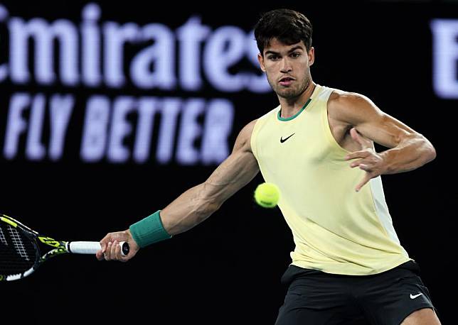 Carlos Alcaraz of Spain hits a return during the men's singles quarterfinal against Alexander Zverev of Germany at the Australian Open in Melbourne, Australia, Jan. 24, 2024. (Xinhua/Ma Ping)