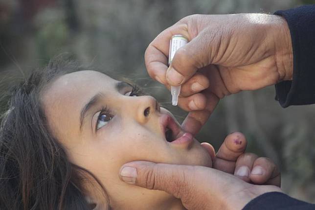 A child receives a dose of polio vaccine in Nangarhar province, east Afghanistan, Nov. 25, 2024. (Photo by Aimal Zahir/Xinhua)