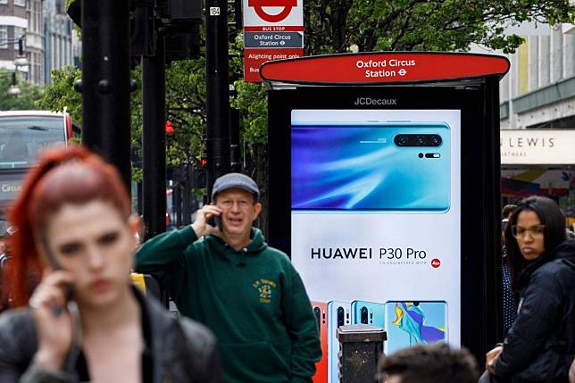 A Huawei advertisement at a bus stop in central London. Photo: AFP