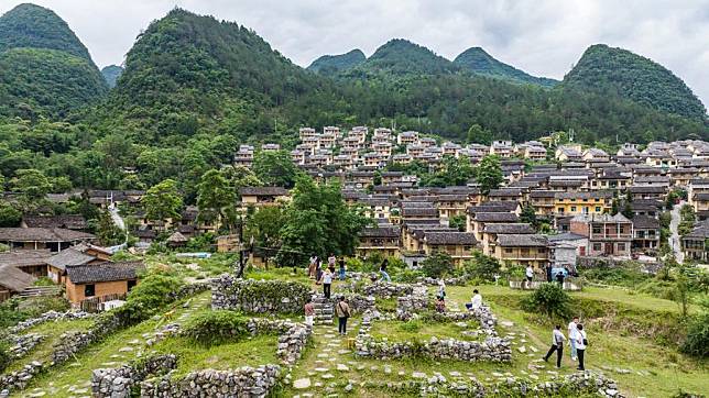 Tourists visit an ancient village in Libo County, southwest China's Guizhou Province, May 16, 2024. (Xinhua/Tao Liang)